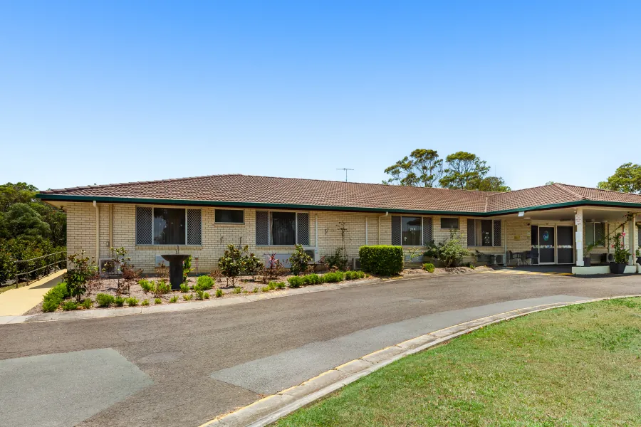 The entrance driveway and single-storey building at Caloundra Place Care Community.