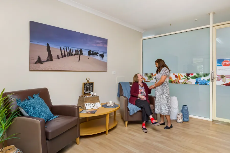 People beside the reception seating area at Caloundra Place Care Community.